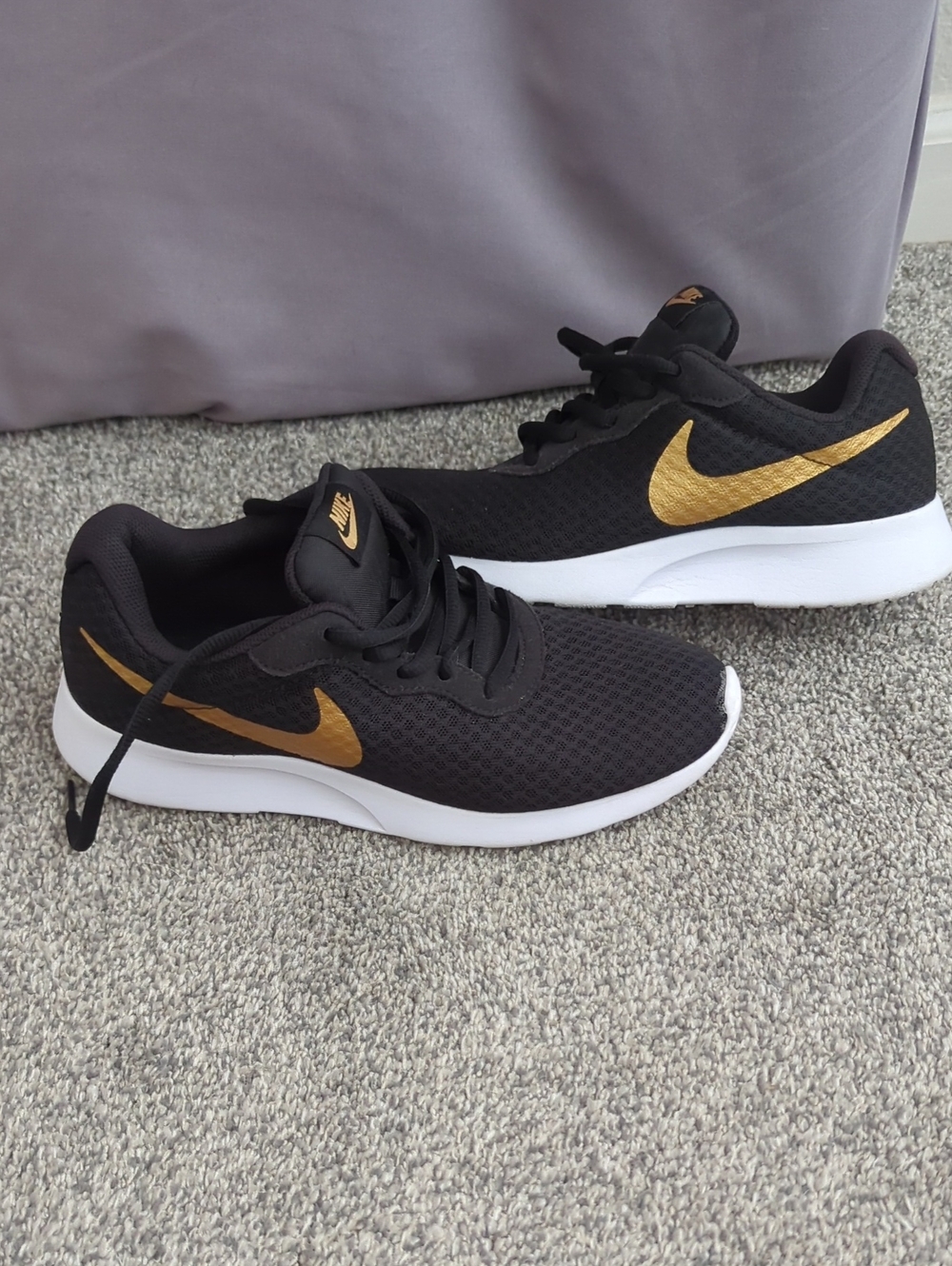 Nike Black Sneakers with Gold Swoosh